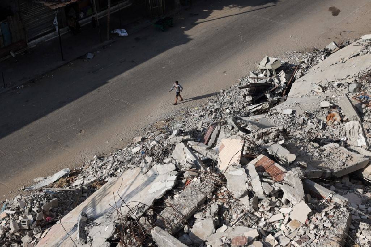 SOLITARY STROLL A Palestinian man walks past the rubble of buildings, which were destroyed in previous Israeli bombardments, in the city of Rafah, southern Gaza Strip, on Tuesday, April 30, 2024. AFP PHOTO