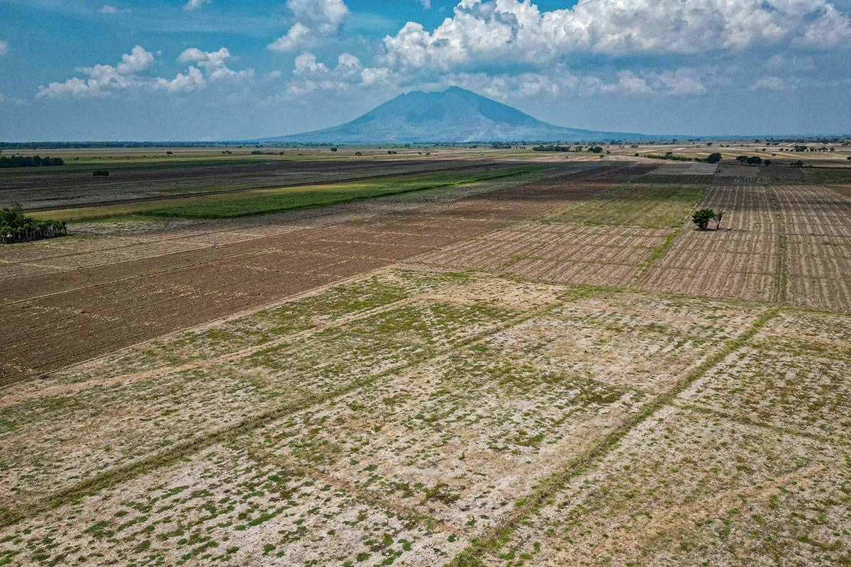 This photo taken on April 25, 2024 shows an aerial view of a drought-stricken farm in San Antonio, Nueva Ecija. More than half of the Philippines' provinces, including Nueva Ecija, are in drought as El Nino exacerbates hot and dry conditions typical for March, April and May. JAM STA ROSA / AFP