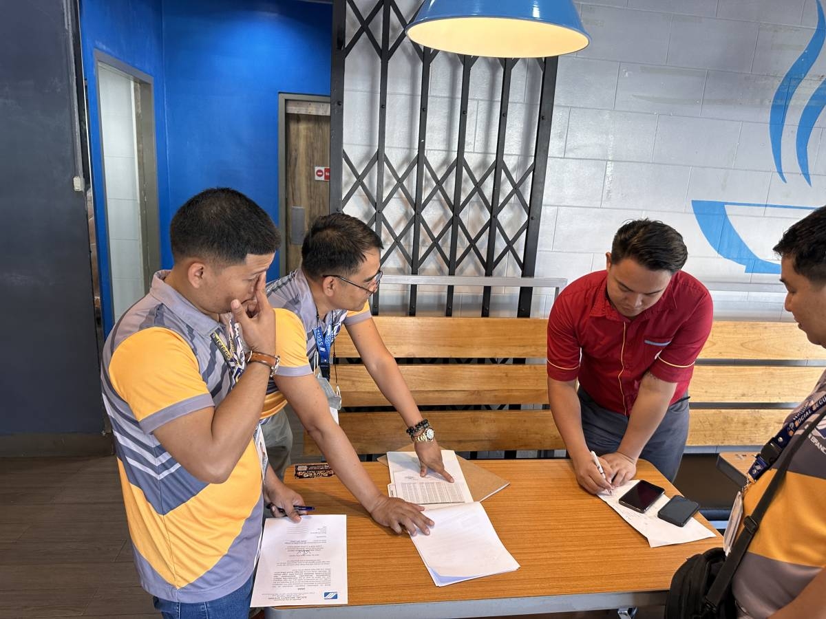 RUNNING AFTER CONTRIBUTION EVADERS A staff of a local food chain signs an ultimatum letter directing the company to pay its arrears on principal and penalties from the Social Security System as government workers look on during Run After Contribution Evaders visitation of delinquent business establishments in City of Ilagan on Tuesday, April 30, 2024. PHOTO BY VINCE JACOB VISAYA