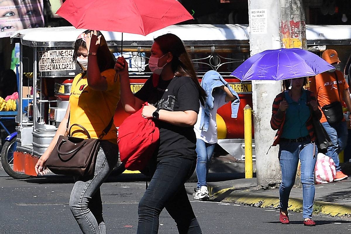 People walk with umbrellas during a heatwave in Manila on April 29, 2024. Unusually hot weather in the Philippines was expected to last until mid-May, a forecaster said April 28, after the temperature hit a record high in the capital Manila.
Ted ALJIBE / AFP