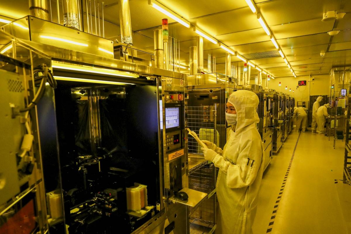 This photo taken on April 29, 2024 shows employees working at a semiconductor chips factory in Huai'an, in eastern China's Jiangsu province. STR / AFP