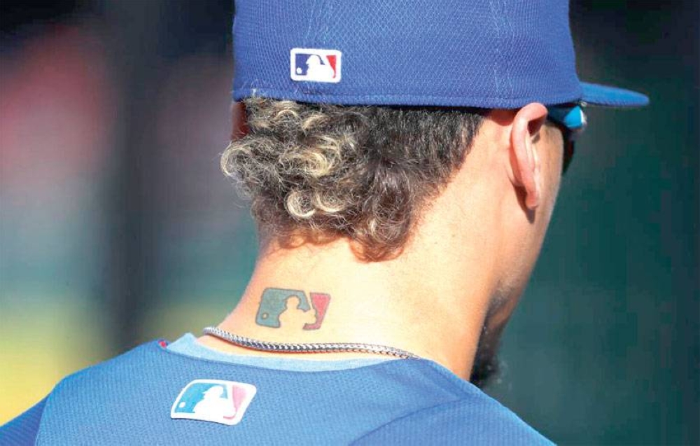 Chicago Cubs' Javier Baez, who has a tattoo of the MLB logo on the back of  his neck, waits to take batting practice before a baseball game against the  Arizona Diamondbacks, Saturday