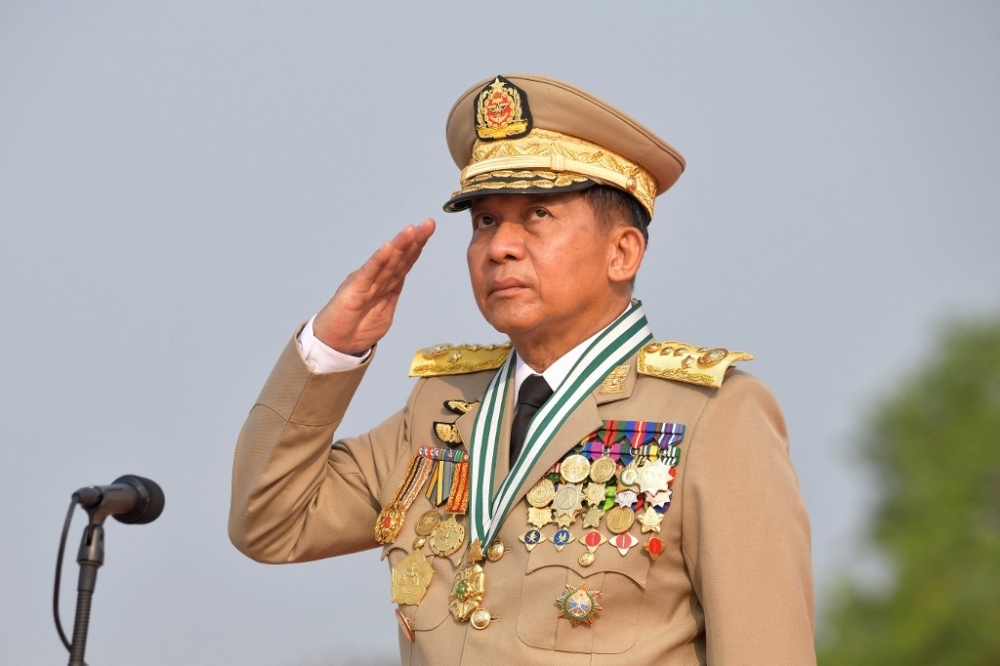 DON’T LOOK UP This March 27, 2022 file photo shows Min Aung Hlaing saluting at a ceremony celebrating Myanmar’s 77th Armed Forces Day in the capital Naypyitaw. MYANMAR MILITARY INFORMATION TEAM PHOTO VIA AFP