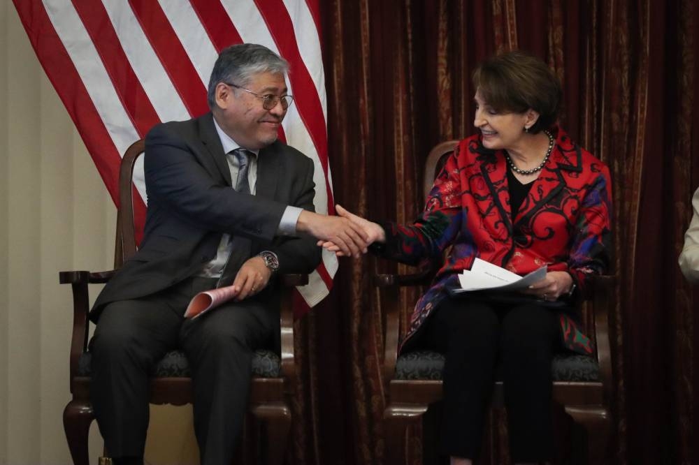 LET'S SHAKE ON IT Philippine Foreign Affairs Secretary Enrique Manalo and US Ambassador MaryKay Carlson shake hands at the Mangove Forum on Wednesday, Oct. 26, 2022. Carlson disclosed that the US will give $70 million cash aid to the Philippine military spread over two years for infrastructure improvement, especially on the proposed expansion of the Enhanced Defense Cooperation Agreement (EDCA). PHOTO BY J. GERARD SEGUIA