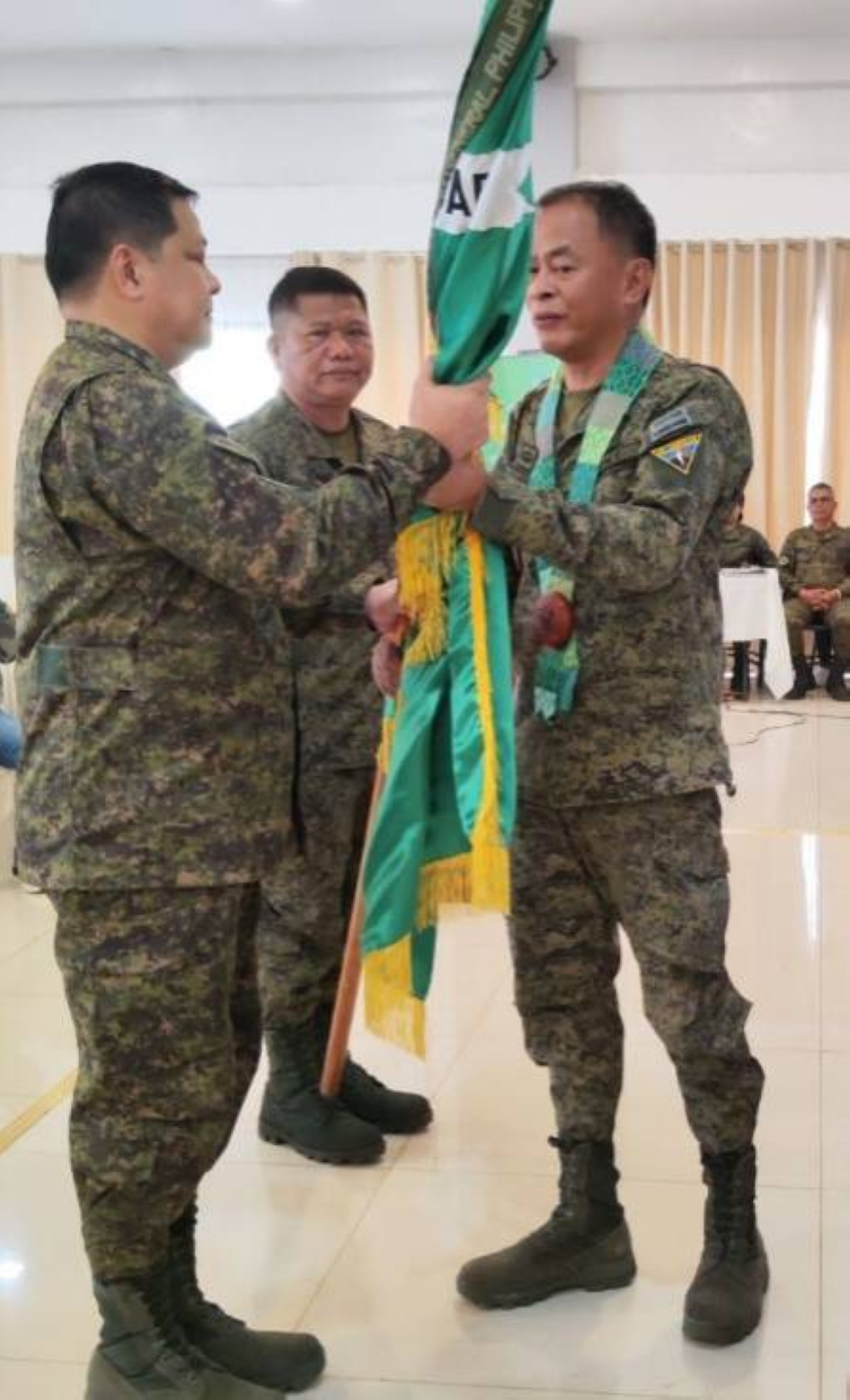 NEW CHIEF Deputy brigade commander Col. Billy de la Rosa(right) turns over the symbolic flag to Brig. Gen. Yegor Rey Barroquillo Jr.(left), the new commander of the 103rd Infantry Brigade, as presidingofficer Maj. Gen. Antonio Nafarette, commander of the 1st Infantry Division,looks on, on Jan. 28, 2023. CONTRIBUTED PHOTO