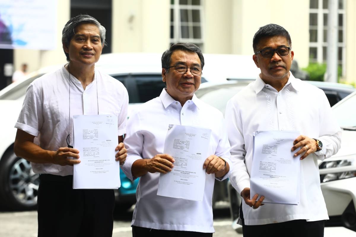 Former party-list representative Neri Colmenares, Bayan Muna Representative Isagani Zarate, and Bayan Muna former representative Ferdinand Gaite, hold up a petition for Certiorari and Prohibition document against Maharlika funds in front of the Supreme Court along Padre Faura in Manila, on Monday, September 18, 2023. PHOTOS BY MIKE ALQUINTO