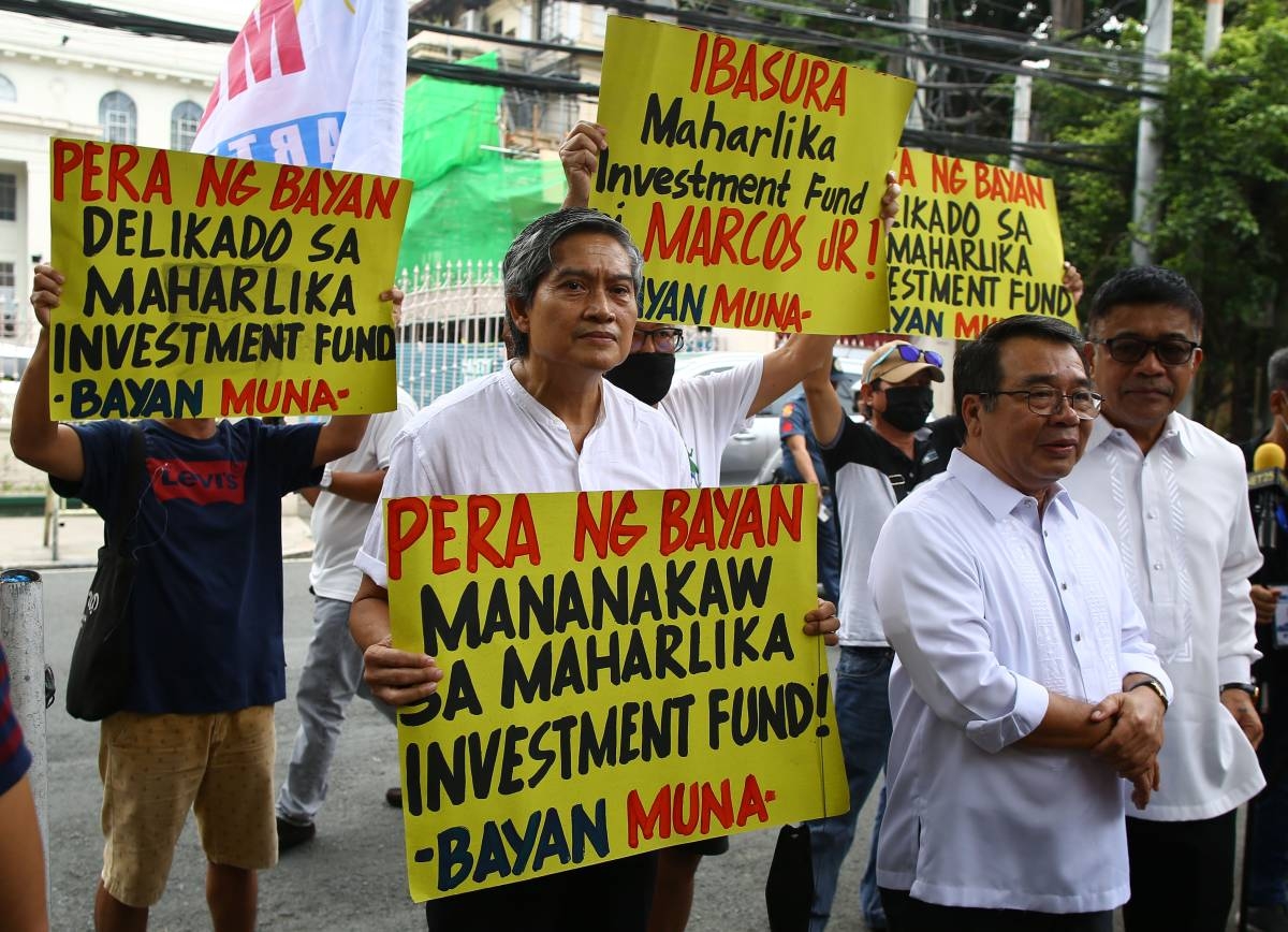 Former party-list representative Neri Colmenares, Bayan Muna Representative Isagani Zarate, and Bayan Muna former representative Ferdinand Gaite, hold up a petition for Certiorari and Prohibition document against Maharlika funds in front of the Supreme Court along Padre Faura in Manila, on Monday, September 18, 2023. PHOTOS BY MIKE ALQUINTO