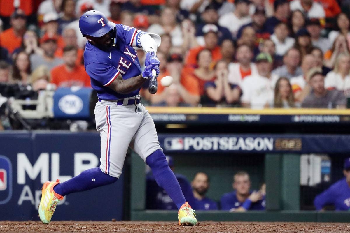 Adolis Garcia of the Texas Rangers fields a ball during the first