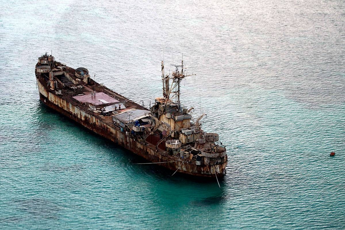 This aerial photograph taken from a military aircraft shows the dilapidated Sierra Madre ship of the Philippine Navy anchored near Ayungin shoal (Second Thomas Shoal) with Philippine soldiers on-board to secure the perimeter in the Spratly group of islands in the South China Sea, west of Palawan, on May 11, 2015. AFP PHOTO / POOL / RITCHIE B. TONGO