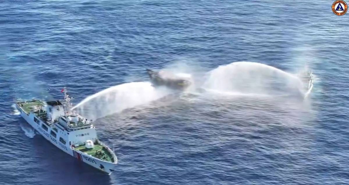 BOMBARDMENT In this frame grab from aerial video footage taken on Tuesday, March 5, 2024, and released by the Philippine Coast Guard, China Coast Guard ships (left and right) deploy water cannons at the Philippine military-chartered civilian boat Unaizah May 4 during its supply mission near Second Thomas Shoal in the disputed South China Sea. AFP PHOTO