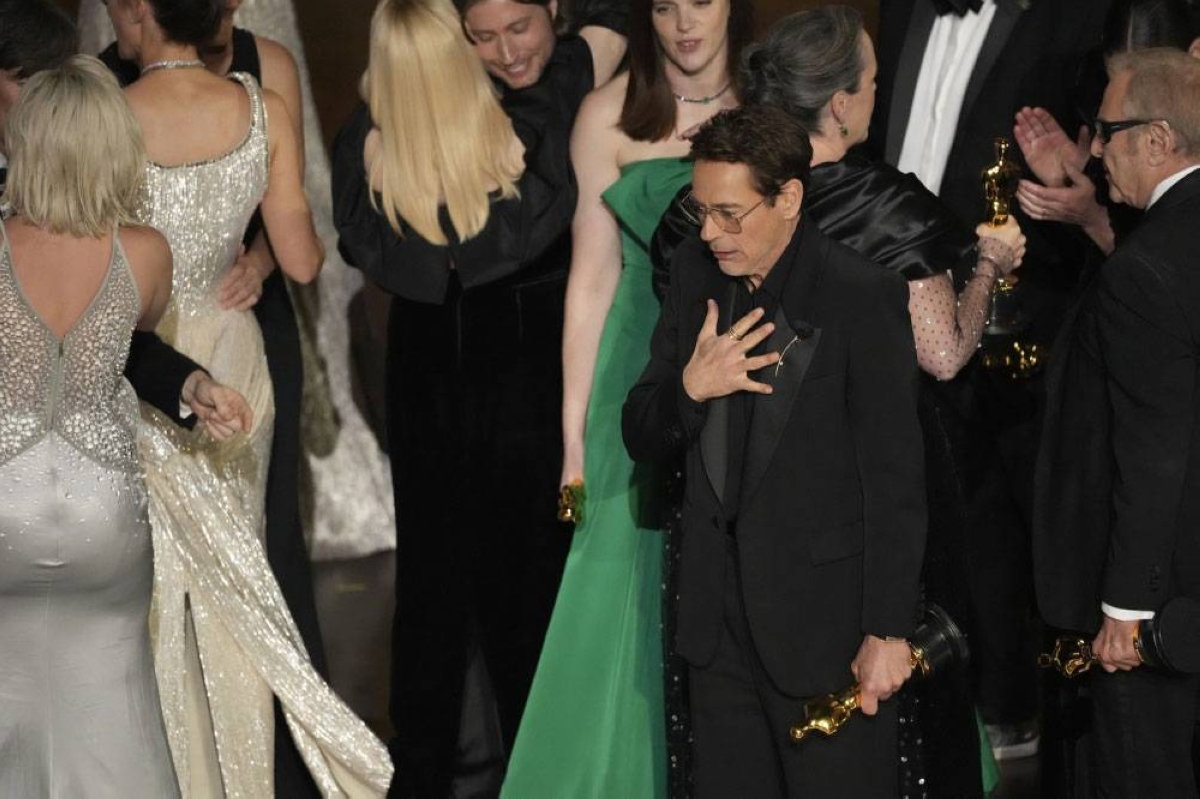 Robert Downey Jr. reacts as the cast and crew of ‘Oppenheimer’ accept the award for Best Picture.