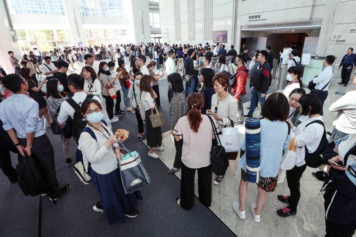 This photo taken by Taiwan's Central News Agency (CNA) on April 3, 2024 shows people gathering in the lobby of the Taipei 101 office building in Taipei, after a major earthquake hit Taiwan's east. Photo by CNA / AFP