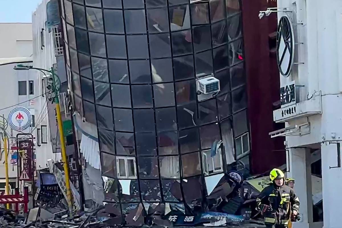 This screenshot taken from a UGC video handout from a user known as Way shows a firefighter running past a damaged building in Hualien on April 3, 2024, after a major earthquake hit Taiwan's east. AFP PHOTO / UGC via user Way