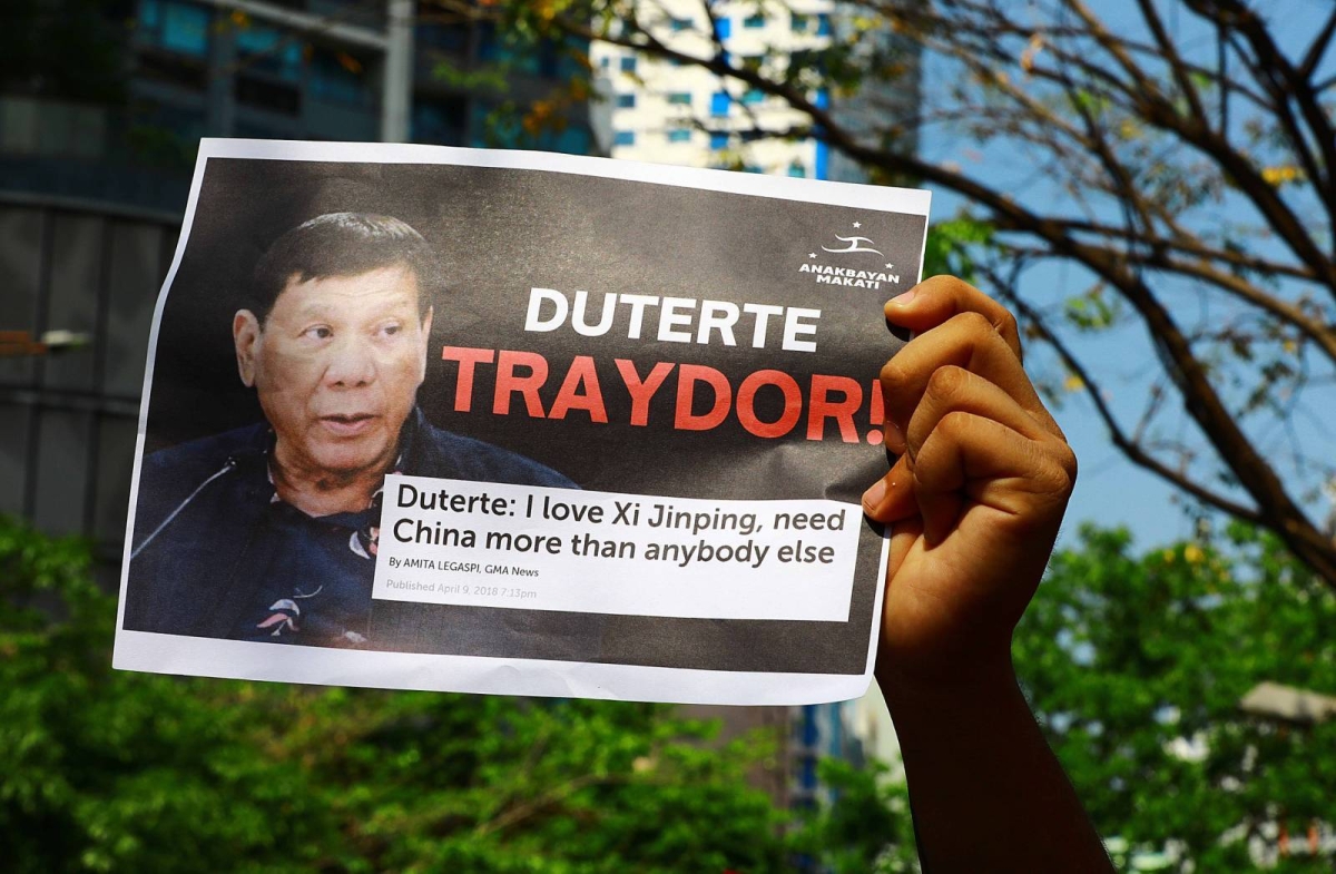 Protesters hold an effigy of Chinese President Xi Jin Ping in front of the Chinese Embassy in Makati City on Tuesday, April 9, 2024 as they condemn Beijing's repeated harassment of Filipino fisherfolk and Philippine supply missions in the West Philippine Sea. PHOTO BY MIKE ALQUINTO