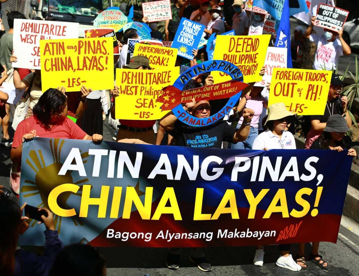 Protesters hold an effigy of Chinese President Xi Jin Ping in front of the Chinese Embassy in Makati City on Tuesday, April 9, 2024 as they condemn Beijing's repeated harassment of Filipino fisherfolk and Philippine supply missions in the West Philippine Sea. PHOTO BY MIKE ALQUINTO