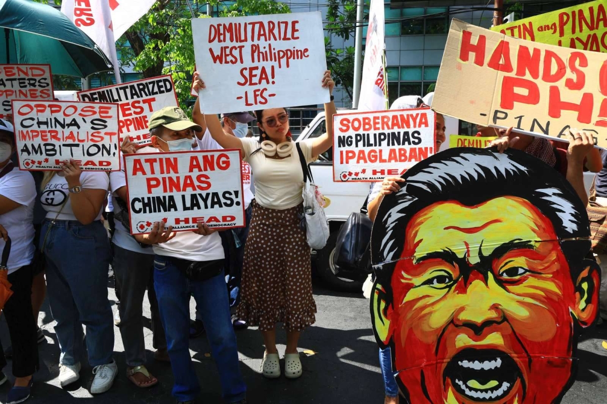 Protesters hold an effigy of Chinese President Xi Jin Ping in front of the Chinese Embassy in Makati City on Tuesday, April 9, 2024 as they condemn Beijing's repeated harassment of Filipino fisherfolk and Philippine supply missions in the West Philippine Sea. PHOTO BY MIKE ALQUINTO