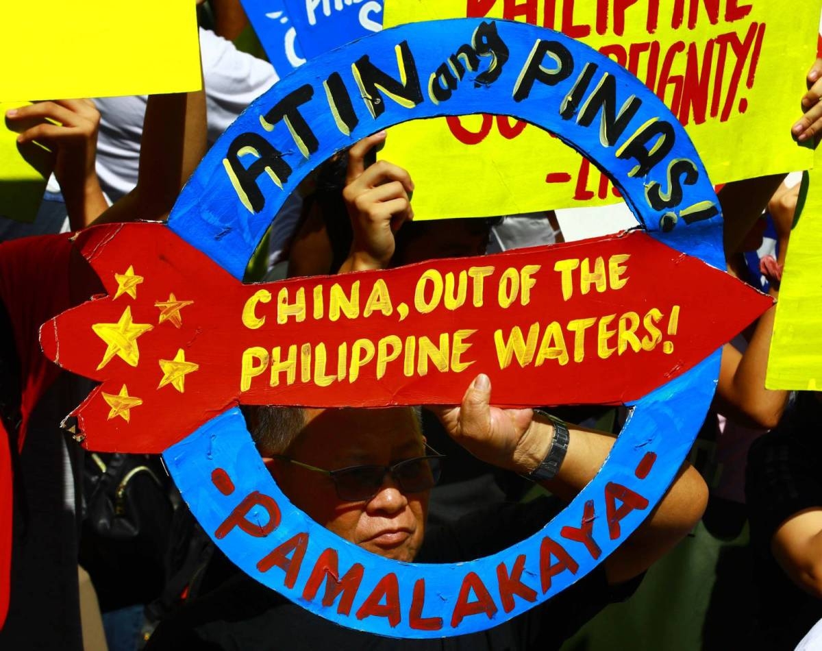 Protesters hold an effigy of Chinese President Xi Jin Ping in front of the Chinese Embassy in Makati City on Tuesday, April 9, 2024 as they condemn Beijing's repeated harassment of Filipino fisherfolk and Philippine supply missions in the West Philippine Sea. PHOTO BY MIKE ALQUINTO