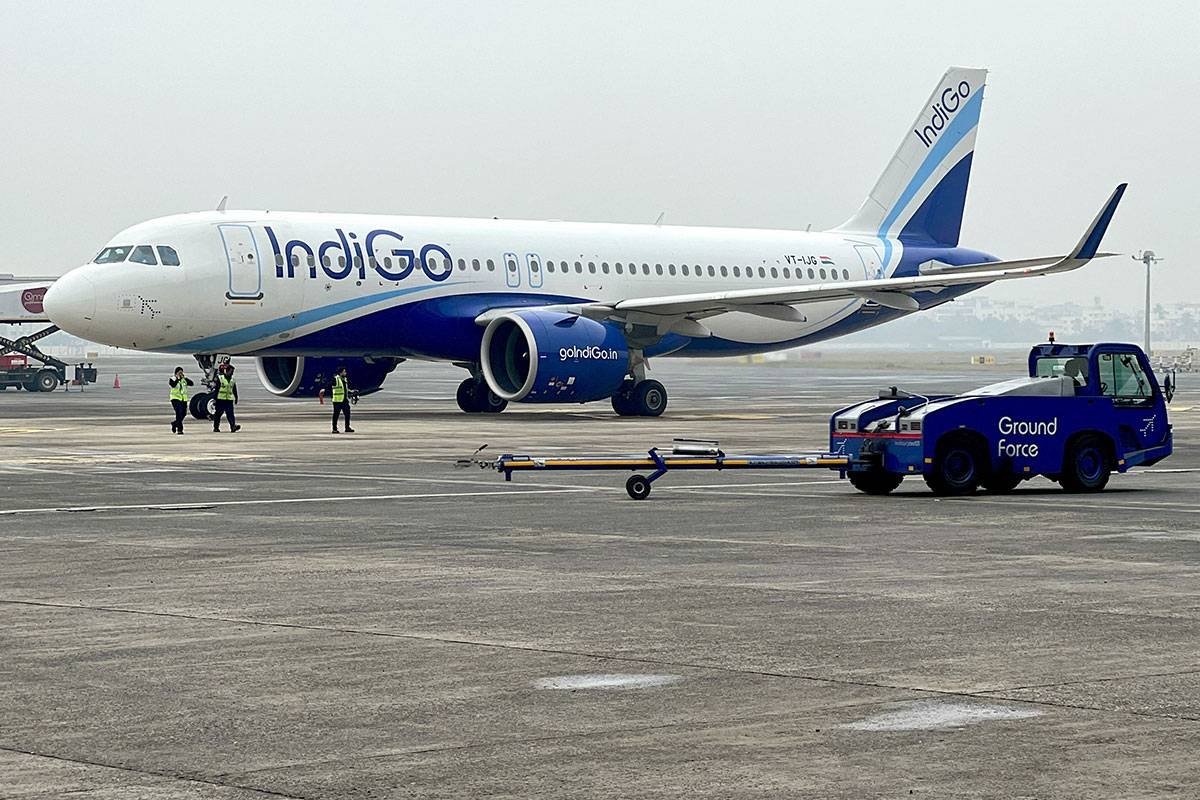TAKING OFF Ground staff walk past an Airbus IndiGo aircraft taxiing at the Netaji Subhash Chandra Bose International Airport in Kolkata, India, on Feb. 1, 2024. Airbus reported on Thursday, April 25, 2024, a 28-percent increase in its first-quarter profits. AFP PHOTO