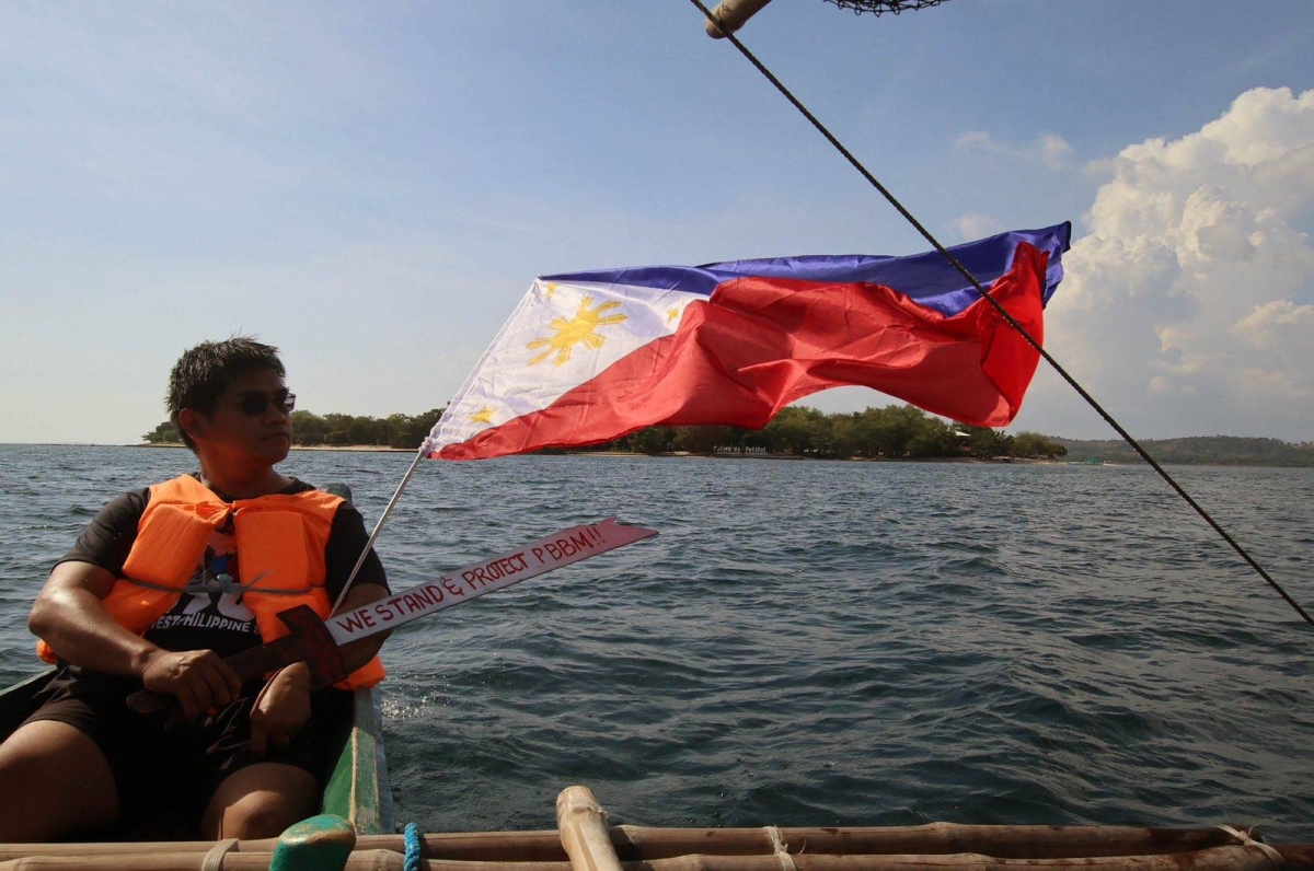 Fisherfolk from Zambales, along with Alyansa Bantay Kapayapaan at Demokrasya, wave a Philippine flag during a fluvial parade in the West Philippine Sea in Candelaria, Zambales, on Saturday, May 11, 2024, to express their condemnation of the harassment by the Chinese Coast Guard of Filipino fishermen. PHOTOS BY ISMAEL DE JUAN 