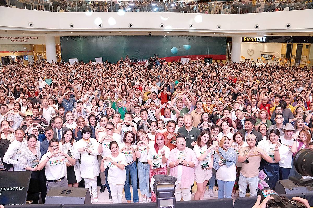 HEARTS FOR PH TOURISM First lady Liza Araneta-Marcos and Tourism Secretary Christina Frasco join Go Negosyo founder Joey Concepcion in making a heart sign, along with more than a thousand attendees at the Tourism Summit 2024 at the Ayala Malls Manila Bay. Go Negosyo gathered tourism companies, tourism MSMEs, students, travel influencers and content creators last May 13 in a daylong event to highlight the vast opportunities offered by the tourism industry to MSMEs. CONTRIBUTED PHOTO