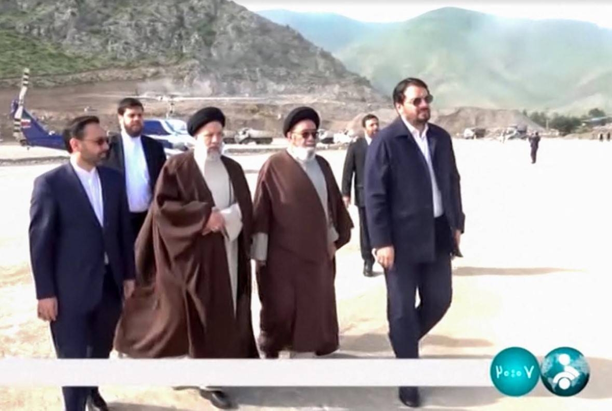 This grab taken from handout video footage released by the IRINN Iranian state television network on May 19, 2024 shows Iran's President Ebrahim Raisi (2nd left front) visiting the Jofa region of the western province of East Azerbaijan. AFP