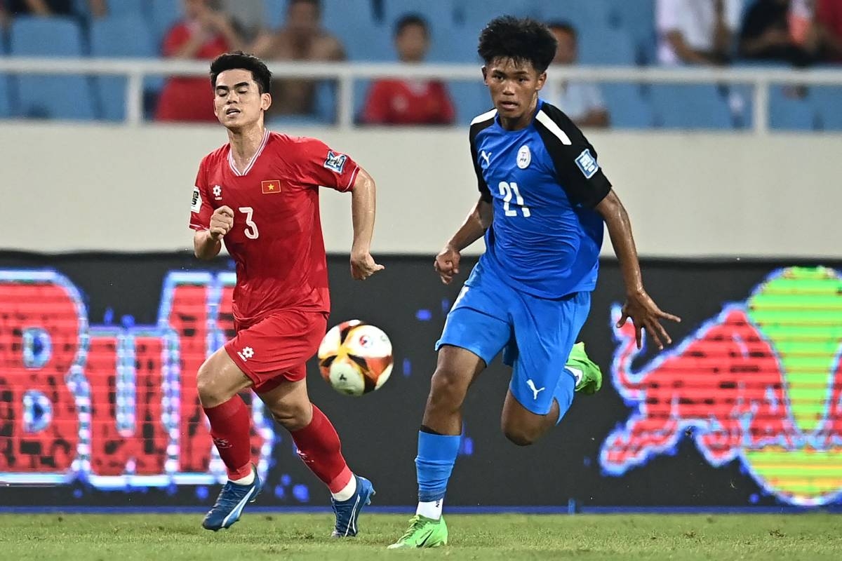 Santiago Rublico (right) of the Philippines runs with the ball past Vietnam's Khuat Van Khang (left) during the 2026 FIFA World Cup AFC qualifiers football match between Vietnam and the Philippines at the My Dinh National Stadium in Hanoi on June 6, 2024. AFP PHOTO