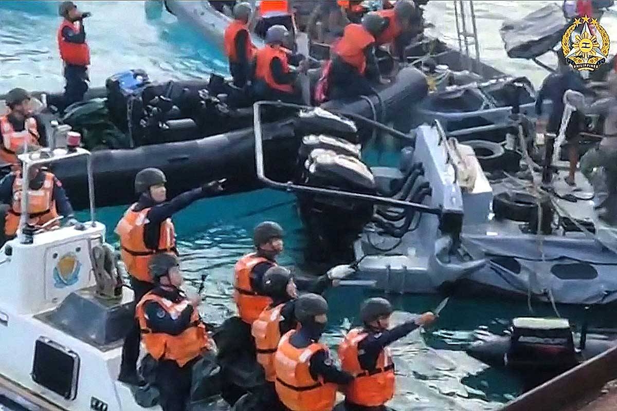 This frame grab from handout video taken on June 17, 2024 and released by the Armed Forces of the Philippines Public Affairs Office on June 19 shows China coast guard personnel appearing to wield bladed weapons during an incident off Second Thomas Shoal in the South China Sea. The Philippine military said on June 19 the Chinese coast guard rammed and boarded Filipino navy boats in a violent confrontation in the South China Sea this week in which a Filipino sailor lost a thumb. China defended its actions, with its foreign ministry saying on Wednesday that 