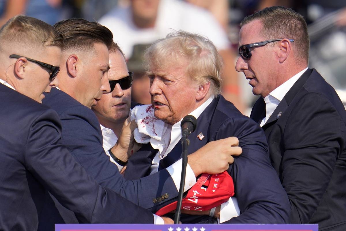 Republican presidential candidate former President Donald Trump is helped off the stage at a campaign event in Butler, Pennsylvania, on Saturday, July 13, 2024. AP PHOTO