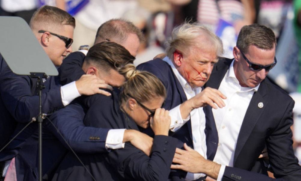BLOODY EAR Republican presidential candidate former president Donald Trump is helped off the stage by US Secret Service agents at a campaign event in Butler, Pennsylvania, on July 13, 2024. AP PHOTO