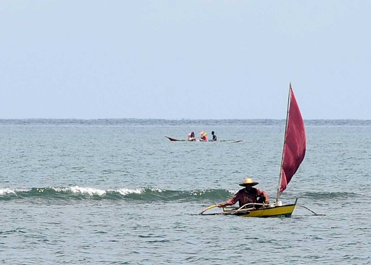 In this file photo a Filipino fisherman returns after fishing at Masinloc bay to Masinloc town, Zambales province. AFP file photo