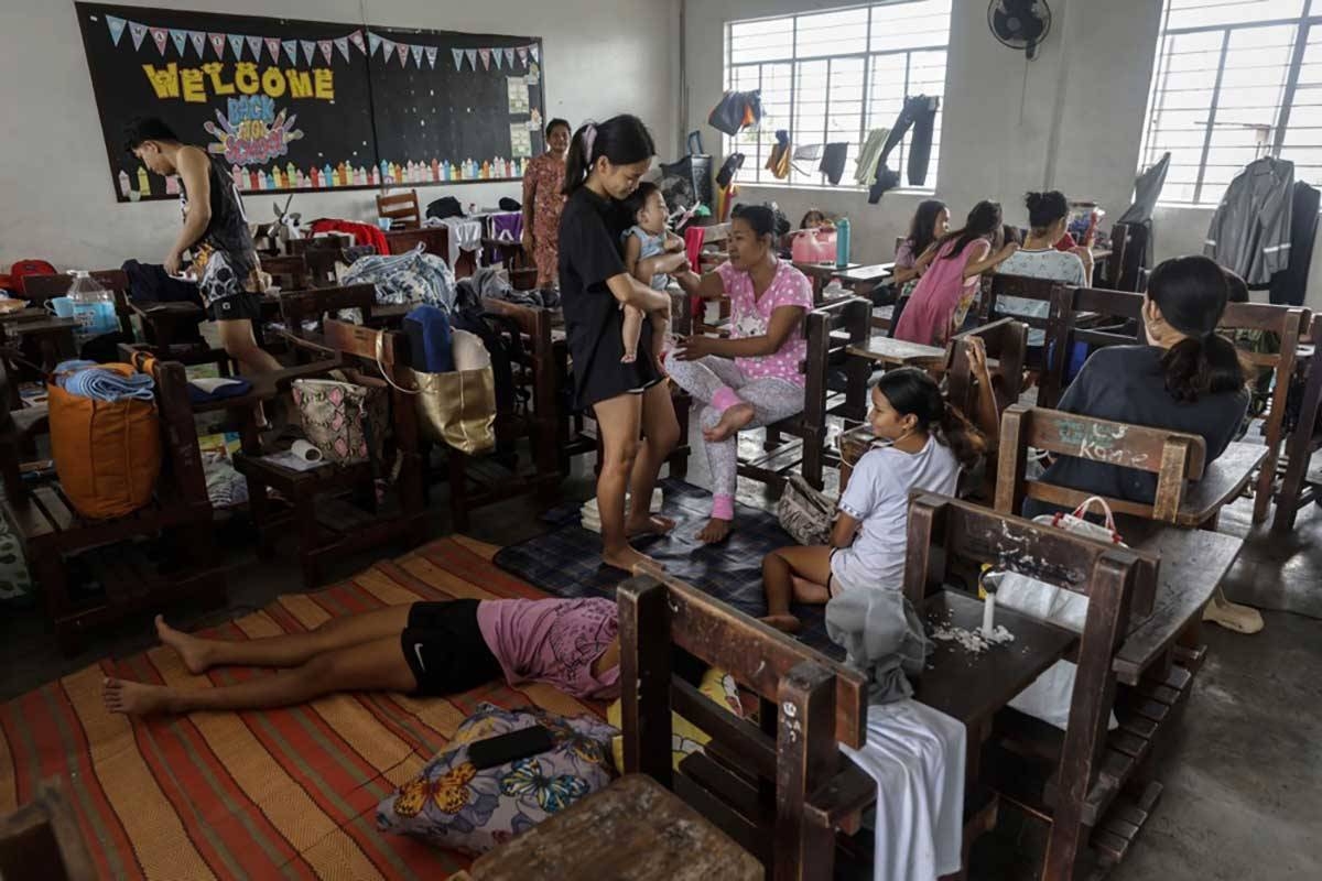 Families affected by flood remain inside a classroom of a school used as an evacuation center in Marikina City, Metro Manila, Philippines, 25 July 2024. EPA-EFE/ROLEX DELA PENA