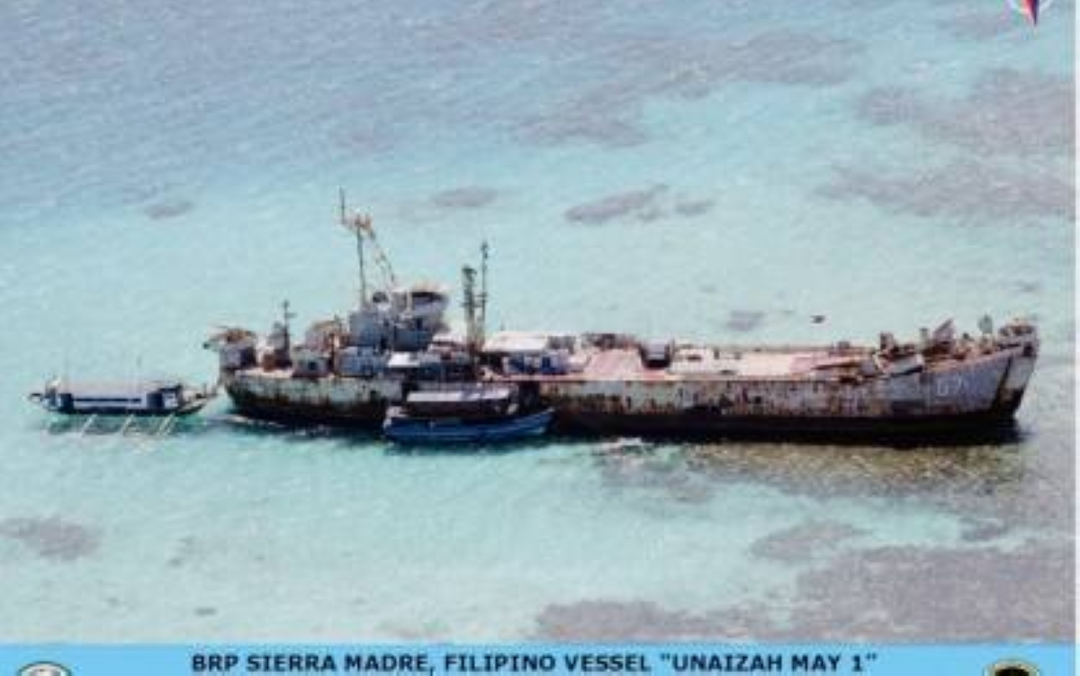 SUCCESSFUL RESUPPLY MISSION. The BRP Sierra Madre is resupplied by civilian vessels Unaizah May 1 and Unaizah May 3 at Ayungin Shoal in the West Philippine Sea in this Nov. 23, 2021 photo. The Department of Foreign Affairs said the Philippines successfully conducted a resupply mission to troops manning the BRP Sierra Madre on July 27, 2024 without any Chinese interference. PHOTO COURTESY OF THE DEPARTMENT OF NATIONAL DEFENSE