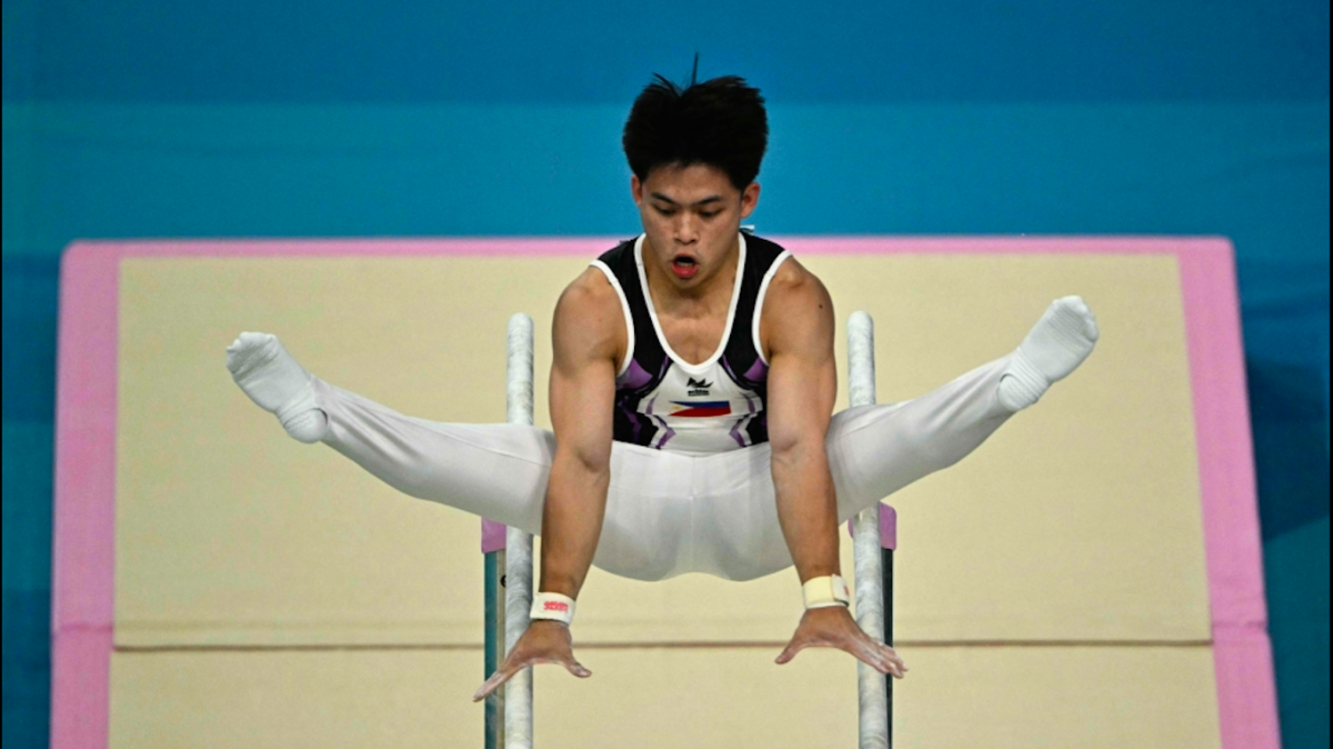 Philippines' Carlos Edriel Yulo competes in the parallel bars event of the artistic gymnastics men's qualification during the Paris 2024 Olympic Games at the Bercy Arena in Paris, on July 27, 2024. AFP PHOTO 