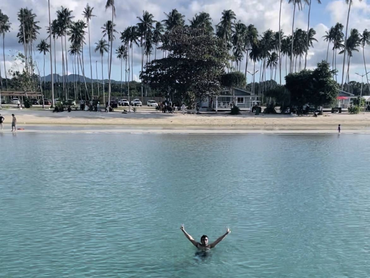 The author takes a ceremonial bath in the pristine Sulu Sea in Omar, Sulu, for first-time visitors to the province. The sand is powdery white, slightly better than that in Boracay and Bohol. Women are not allowed to wear two-piece swimsuits while swimming as the Tausug government seeks to preserve their culture. CONTRIBUTED PHOTOS