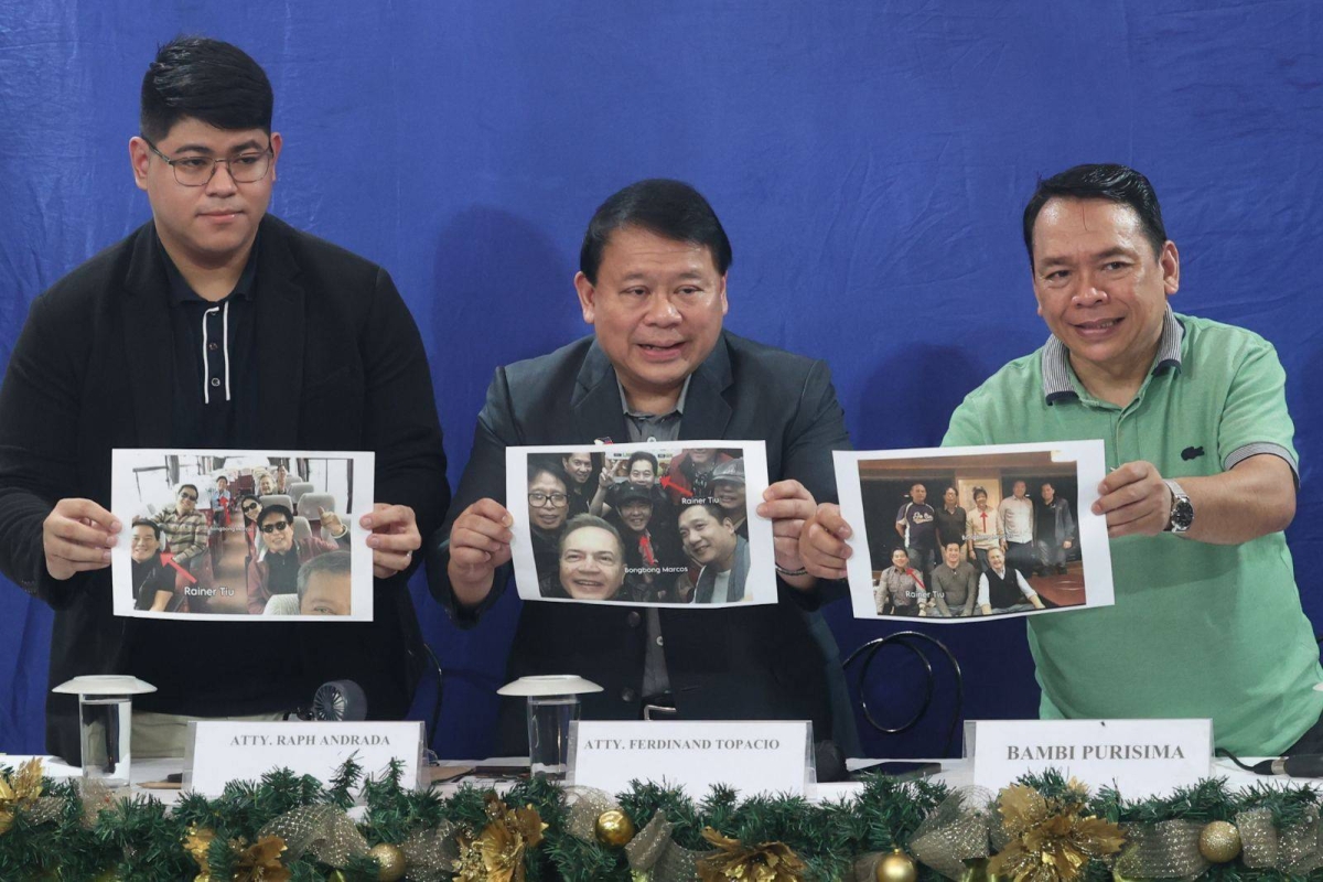 Lawyer Ferdinand Topacio (center) shows an undated photo of President Ferdinand Marcos Jr. (center), together with Rainer Tiu (right) during a press conference in Quezon City on Sept. 7, 2024. Tiu is allegedly 'king' of the Philippine Offshore Gaming Operators (POGOs). Topacio is the lawyer of dismissed town mayor Alice Guo, who has since been deported from Indonesia where she was arrested and has been placed under the custody of the Philippine National Police (PNP). Guo has been linked to illegal POGO operations in her hometown. She is facing multiple charges of money laundering and of fraud, misrepresenting herself as a Filipino. Malacañang has yet to respond to Topacio's disclosure. PHOTOS BY JOHN ORVEN VERDOTE