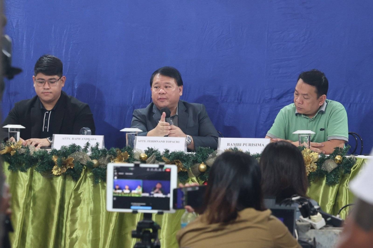 Lawyer Ferdinand Topacio (center) shows an undated photo of President Ferdinand Marcos Jr. (center), together with Rainer Tiu (right) during a press conference in Quezon City on Sept. 7, 2024. Tiu is allegedly 'king' of the Philippine Offshore Gaming Operators (POGOs). Topacio is the lawyer of dismissed town mayor Alice Guo, who has since been deported from Indonesia where she was arrested and has been placed under the custody of the Philippine National Police (PNP). Guo has been linked to illegal POGO operations in her hometown. She is facing multiple charges of money laundering and of fraud, misrepresenting herself as a Filipino. Malacañang has yet to respond to Topacio's disclosure. PHOTOS BY JOHN ORVEN VERDOTE