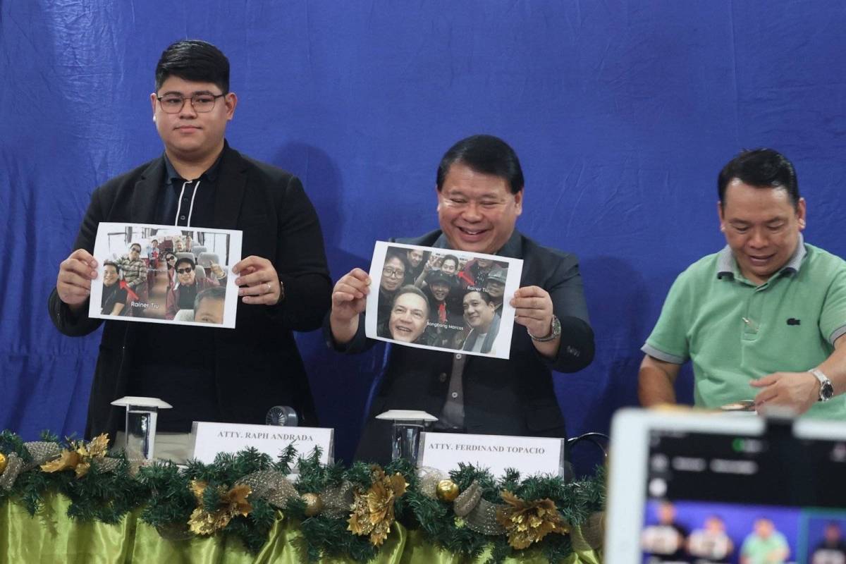 Lawyer Ferdinand Topacio (center) shows an undated photo of President Ferdinand Marcos Jr. (center), together with Rainer Tiu (right) during a press conference in Quezon City on Sept. 7, 2024. Tiu is allegedly 'king' of the Philippine Offshore Gaming Operators (POGOs). Topacio is the lawyer of dismissed town mayor Alice Guo, who has since been deported from Indonesia where she was arrested and has been placed under the custody of the Philippine National Police (PNP). Guo has been linked to illegal POGO operations in her hometown. She is facing multiple charges of money laundering and of fraud, misrepresenting herself as a Filipino. Malacañang has yet to respond to Topacio's disclosure. PHOTOS BY JOHN ORVEN VERDOTE