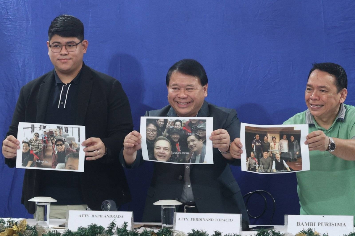 Lawyer Ferdinand Topacio (center) shows an undated photo of President Ferdinand Marcos Jr. (center), together with Rainer Tiu (right) during a press conference in Quezon City on Sept. 7, 2024. Tiu is allegedly 'king' of the Philippine Offshore Gaming Operators (POGOs). Topacio is the lawyer of dismissed town mayor Alice Guo, who has since been deported from Indonesia where she was arrested and has been placed under the custody of the Philippine National Police (PNP). Guo has been linked to illegal POGO operations in her hometown. She is facing multiple charges of money laundering and of fraud, misrepresenting herself as a Filipino. Malacañang has yet to respond to Topacio's disclosure. PHOTOS BY JOHN ORVEN VERDOTE