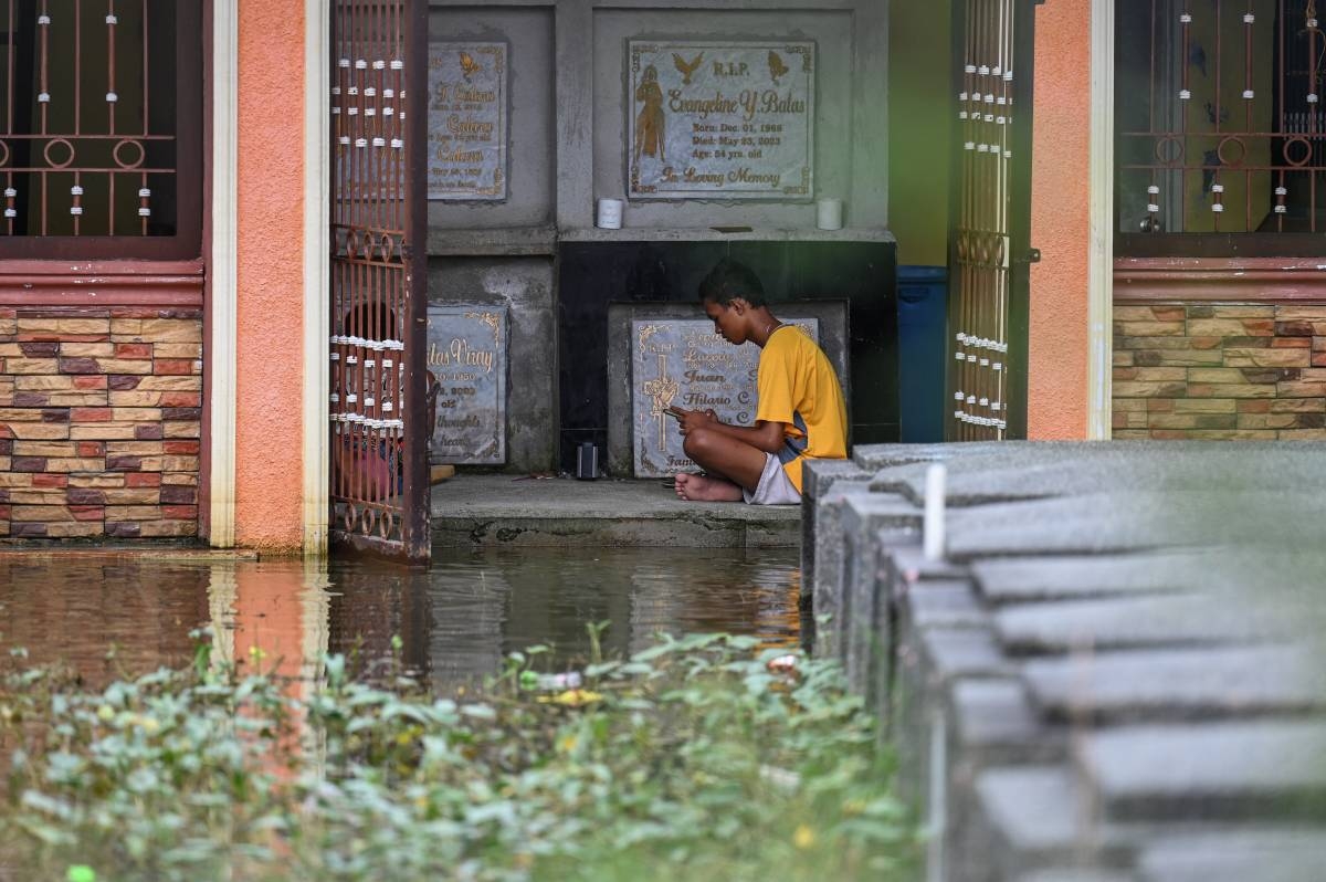 On dry or wet ground, day or night, Filipinos nationwide flock to cemeteries  to visit their dearly departed on Nov. 1, 2024. Here are some of the scenes captured by The Manila Times and Agence France-Presse photographers of this year's 'Undas': The flooded cemeteries at the Sta. Ana Parish in Bulacan and Masantol in Pampanga; the Manila North Cemetery during the day and the Barangka Cemetery in Marikina City and Pasay public cemetery at night; mural artist Jae Valencia applying the finishing touches to the painting on his father's tomb at a cemetery in Pateros. PHOTOS BY ISMAEL DE JUAN, RENE DILAN, J. GERARD SEGUIA, JOHN ORVEN VERDOTE AND AFP.