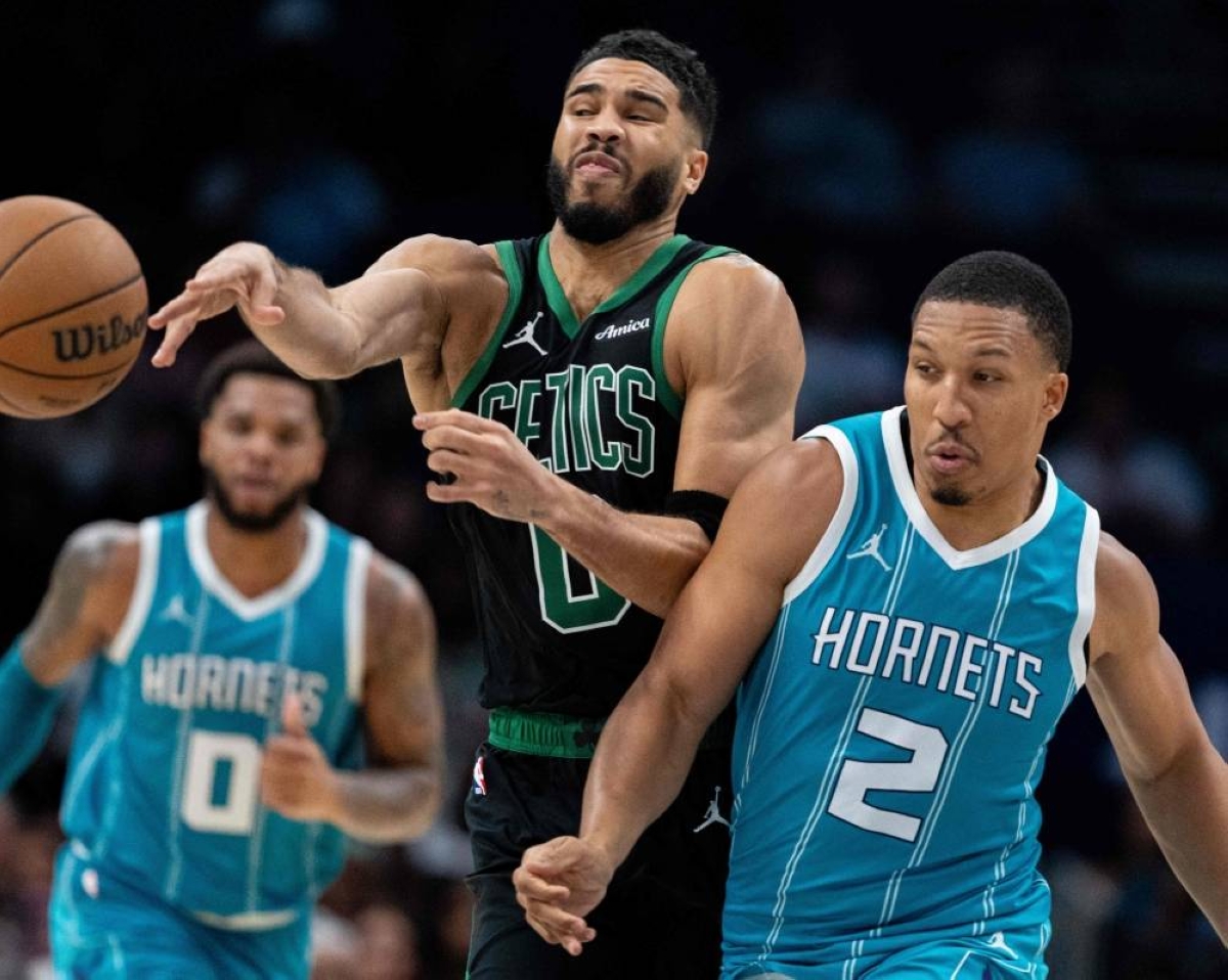 Grant Williams (2) of the Charlotte Hornets fouls Jayson Tatum  of the Boston Celtics in the fourth quarter during their game at Spectrum Center on November 1, 2024 in Charlotte, North Carolina. AFP PHOTO