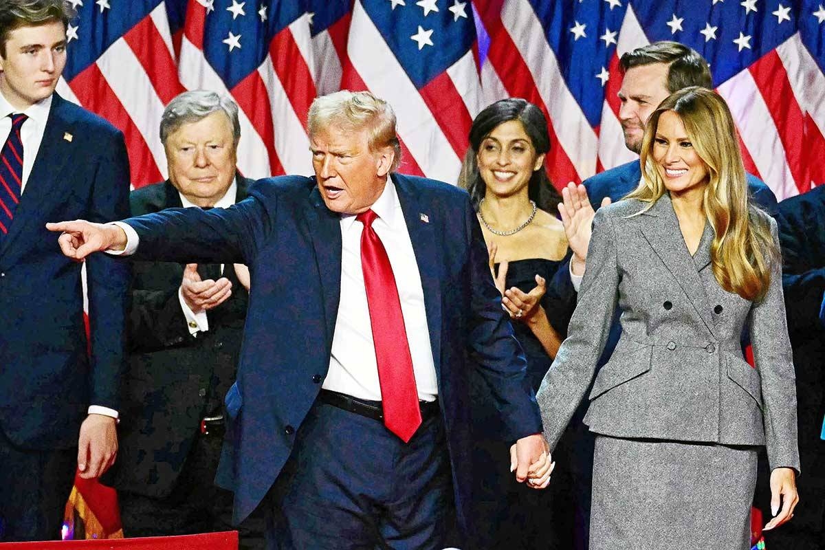 A SECOND TERM Former US president Donald Trump gestures at supporters after speaking as he holds hands with former US first lady Melania Trump during an election night event at the West Palm Beach Convention Center in West Palm Beach, Florida, early on Nov. 6, 2024. PHOTO BY JIM WATSON/AFP