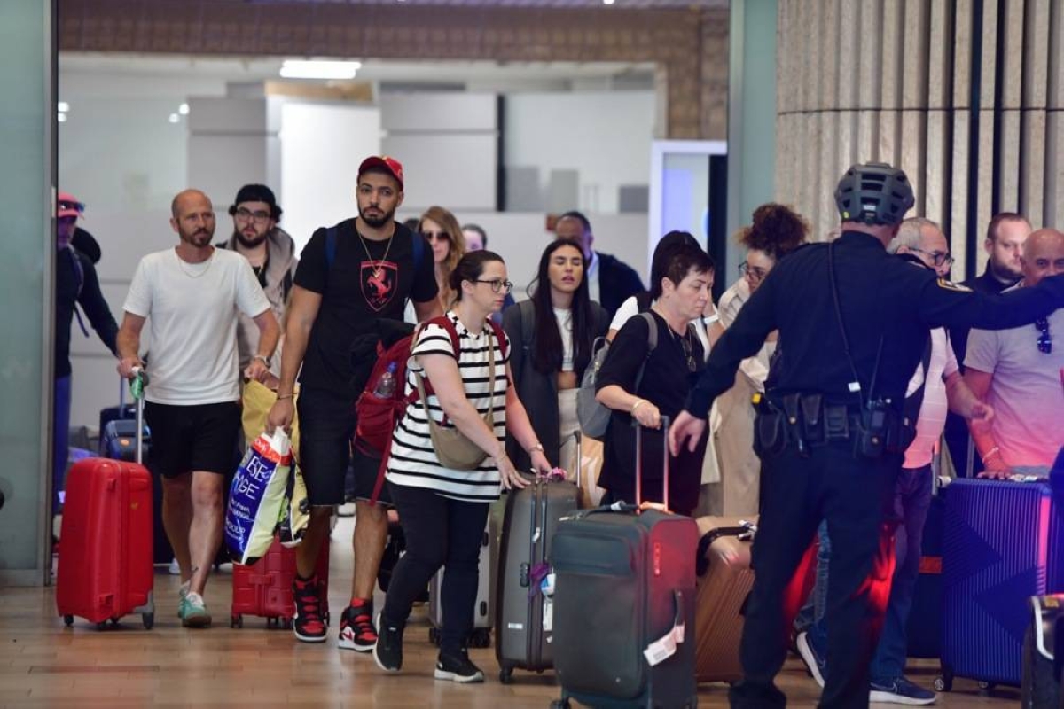 Israeli soccer fans return home after attacks