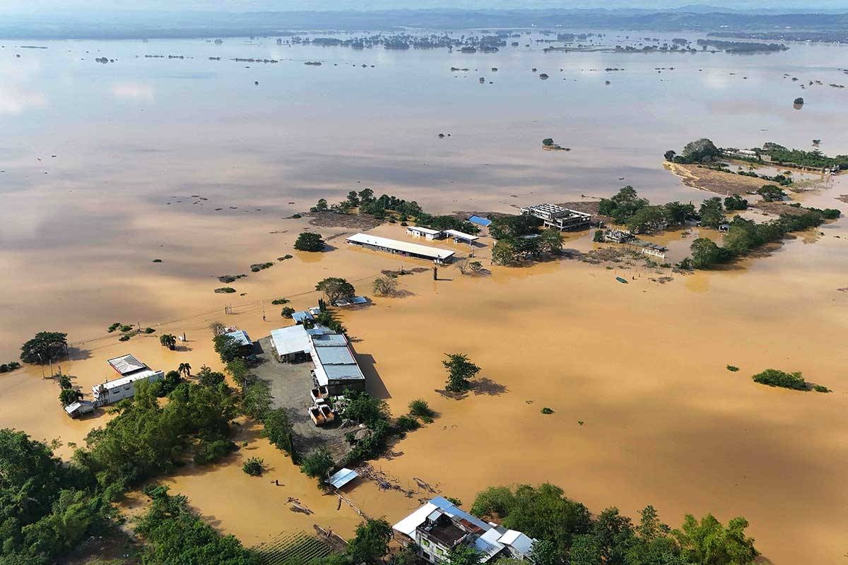 RIVERS OVERFLOW This aerial photo shows houses submerged in floodwaters due to a swollen river caused by heavy rains from Super Typhoon Pepito in Tuguegarao City, Cagayan province, on Nov. 19, 2024. PHOTO BY JOHN DIMAIN/AFP