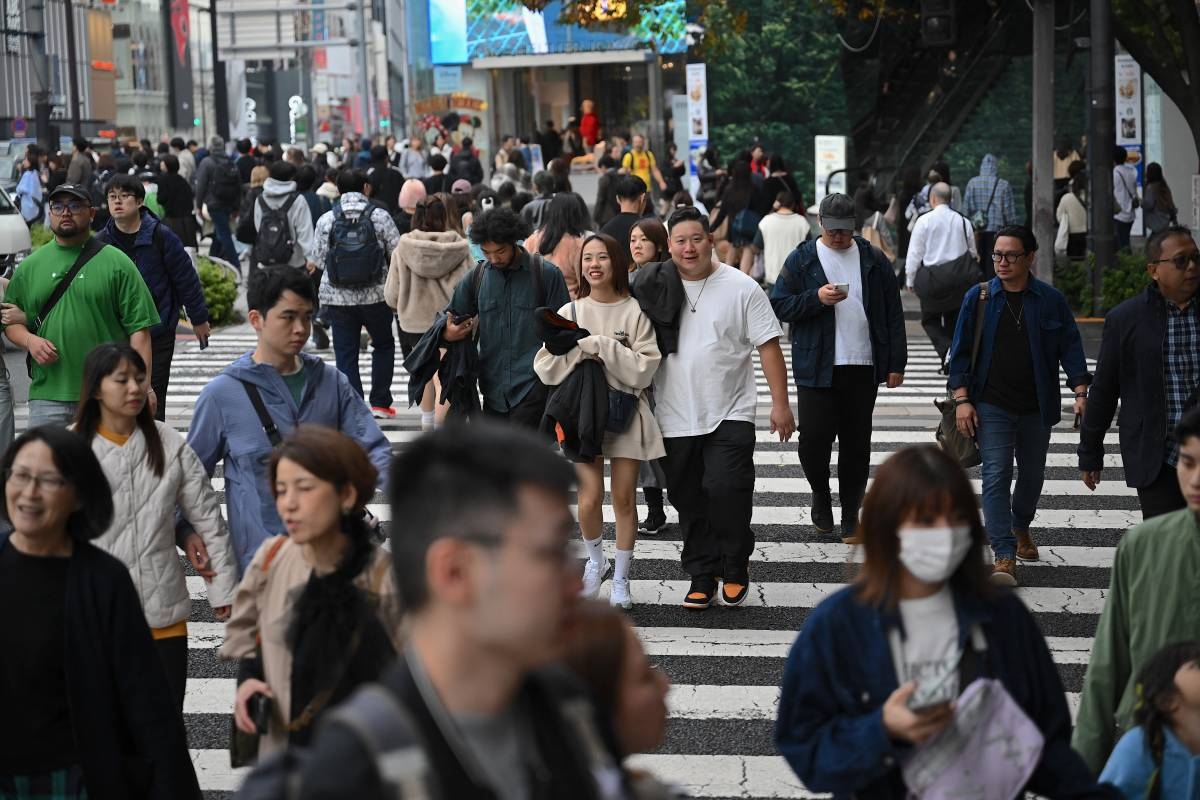 People cross a street in the Omotesando shopping area in Tokyo on November 15, 2024. AFP PHOTO