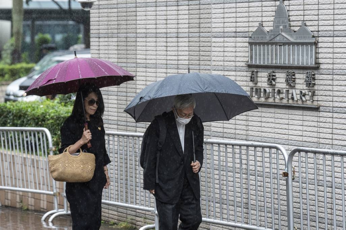 WET WEDNESDAY Jimmy Lai's wife Teresa Lai (left) and retired Chinese Cardinal Joseph Zen Ze-Kiun hold umbrellas to shield themselves from the rain as they arrive at the West Kowloon Magistrates' Courts to attend the activist publisher’s national security trial in Hong Kong on Nov. 20, 2024. AP PHOTO