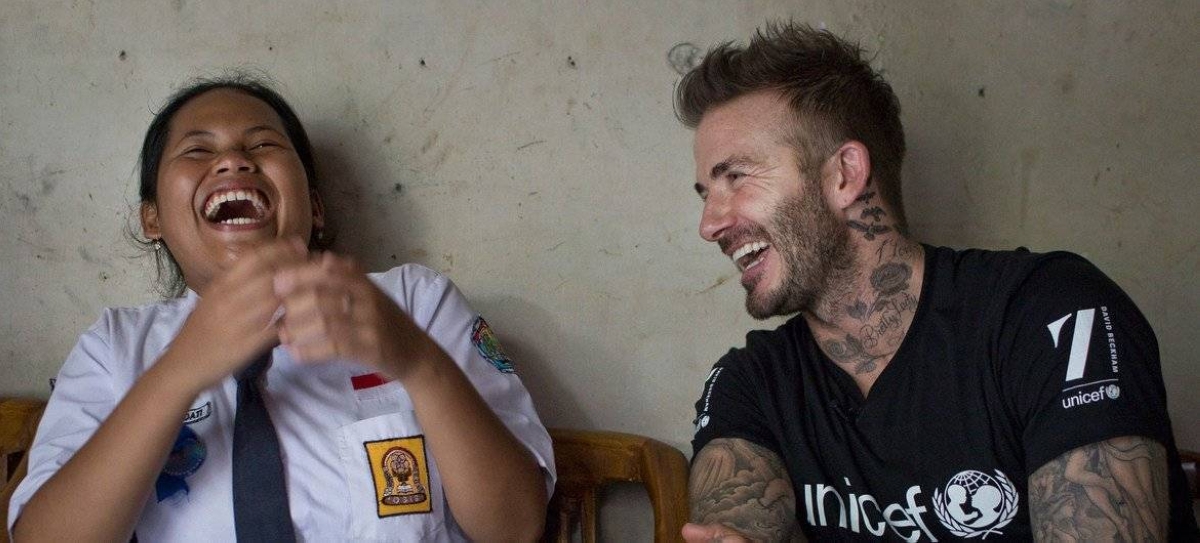 UNICEF Goodwill Ambassador David Beckham shares a laugh with 15-year-old Sripun at her home in Semarang, Indonesia, in 2015. (file) UNICEF/Modola