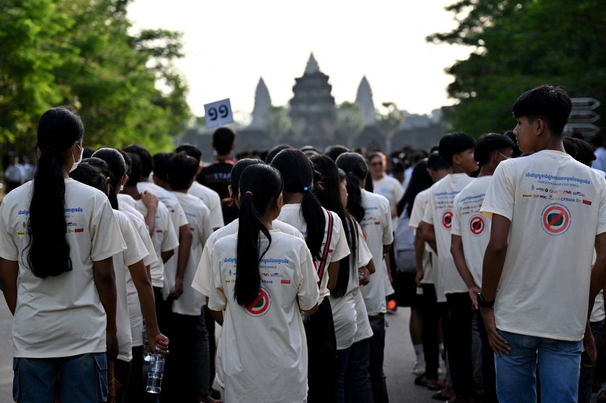 Students gather in front of the Angkor Wat temple as they take part in a march for the banning of landmines as part of the Siem Reap-Angkor Summit on a Mine Free World, in Siem Reap province on November 24, 2024. AFP PHOTO