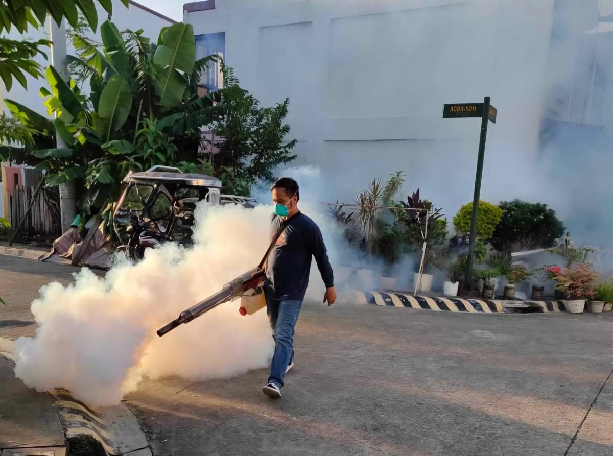 EXTERMINATING MOSQUITOES A personnel from General Trias City Health Office conducts fumigation and misting operations in a neighborhood to extricate mosquitoes from their breeding ground. The city is one of the LGUs in Cavite with high number of cases at 1,183. PHOTO BY DENNIS ABRINA