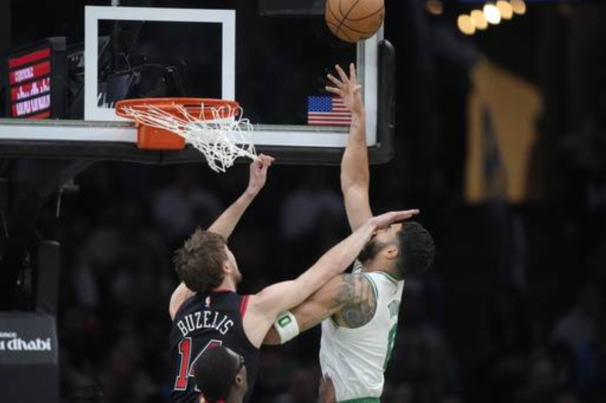 IN YOUR FACE Boston Celtics forward Jayson Tatum (0) takes a shot at the basket as Chicago Bulls forward Matas Buzelis (14) defends in the first half of an NBA basketball game on Dec. 19, 2024, in Boston. AP PHOTO