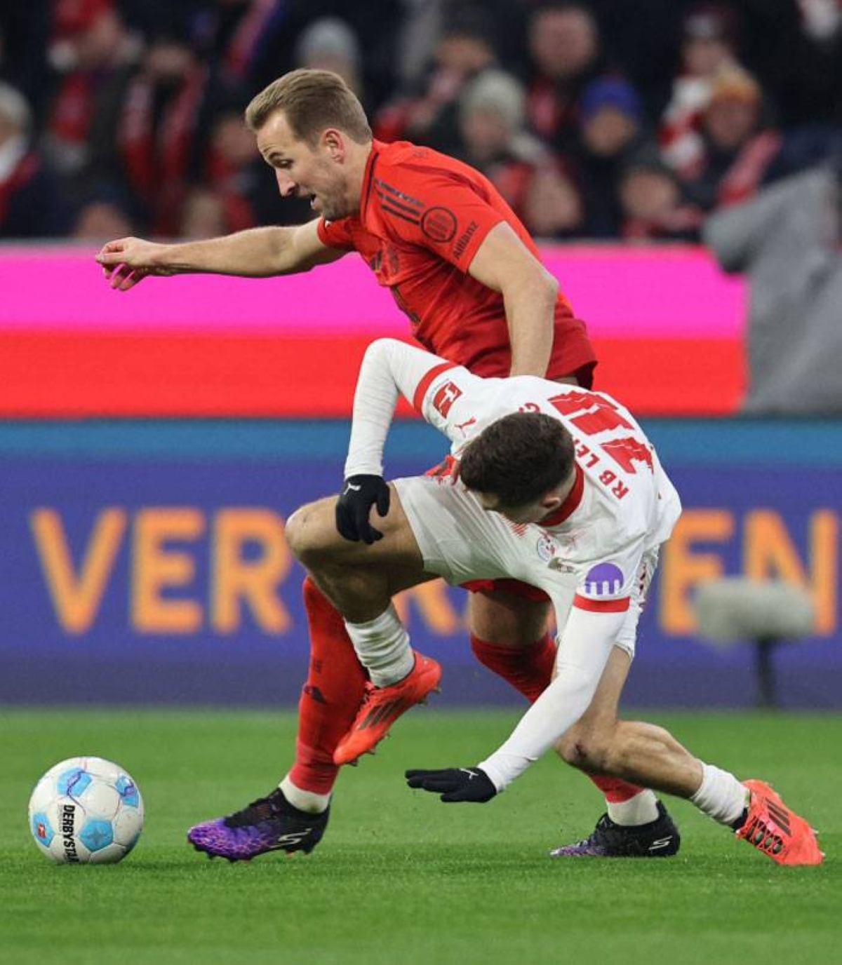 Bayern Munich's English striker Harry Kane (09) and Leipzig's Austrian midfielder Christoph Baumgartner (14) compete for the ball during the German Bundesliga first division football match between FC Bayern Munich and RB Leipzig in Munich, southern Germany, December 20, 2024. PHOTO BY ALEXANDRA BEIER/AFP